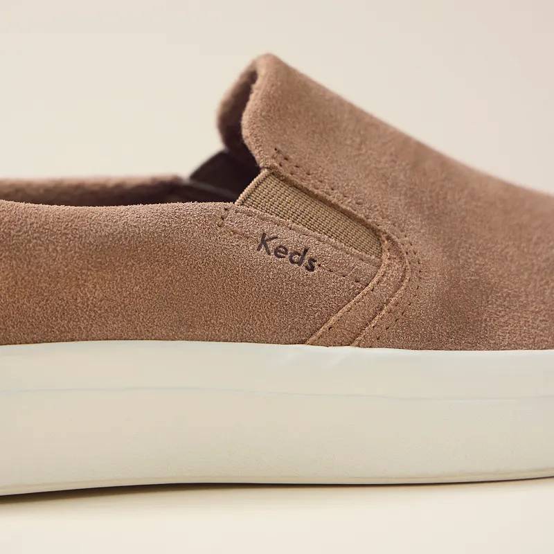 A close-up view of the Pursuit Suede Slip-On Sneaker in trending taupe.